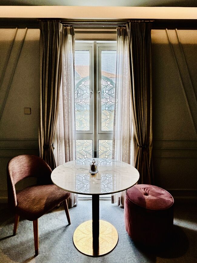 そして、とくに天井が高い！窓側に椅子とテーブルがあってここでも寛げます。<br />このカーテンがなびく様子と窓ガラスの目隠しの模様が、とっても絵になります・・