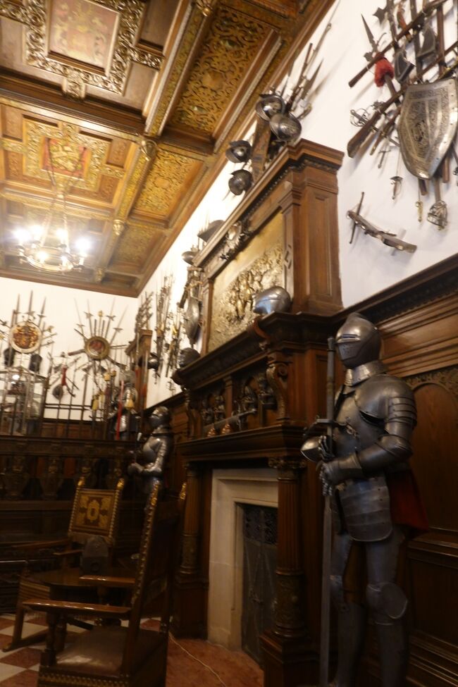 武器・武具展示室<br /><br />天井は木製、白漆喰の壁、木彫り装飾の腰板になっています。<br />暖炉の上の浮彫は、『ニコポリスの戦い』の場面を描いたもの。<br />1396年オスマントルコとハンガリー王ジギスムントが率いる最後の十字軍（イギリス・フランス・ドイツ・イタリアを含むキリスト教国の連合軍）の戦い、