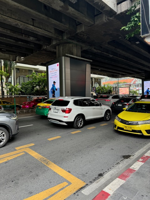 Enbassy前の高架下に6車線ある広い道路。普通は中央分離帯で方向別れますが、よく見ると手前の車線も向こう2車線はあっち行き。（分離帯の向こうもあっち行き）<br />一番の手前の1車線だけがこっち行き。つまり5対1?<br />なんとも不思議なタイの道路事情です…