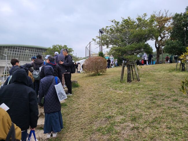 12時予定の開場を30分繰り上げるとアナウンスが入り、入場口周辺に人が集まり始めたところ。