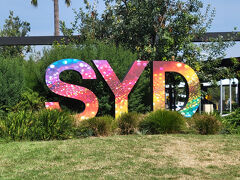 空港の外に出て来て SYD のサインを撮影。
時間によっては空港鉄道よりUberの方が安いことがあると耳にしたので、一応Uberでホテルまでの料金を調べてみましたが、70AUD以上したので諦めて空港鉄道でホテルまで行きたいと思います。