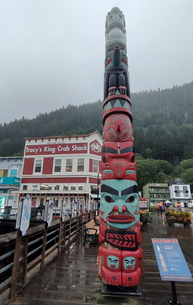 ウッドデッキの上にレイヴン族に属するルクナックス・アディのコホー族のトーテムポールがあります。の氏族の名前はサーモンの産地である川の名前に由来します。デザインには超自然的な出会いによって得られた白いカエルのデザインが含まれています。