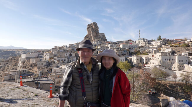 4WDサファリ後の撮影ポイントにて記念撮影<br />後ろに控える奇岩にも洞窟風住居<br />